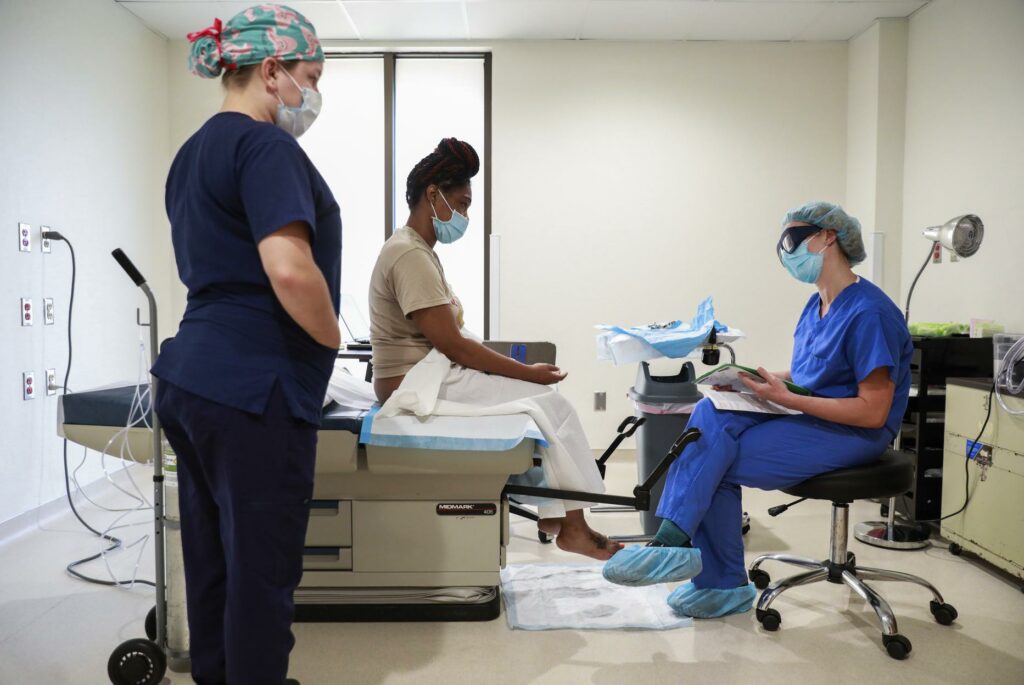 Woman consulting a gynecologist at an abortion clinic. 